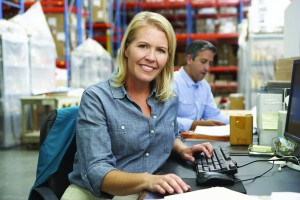 smallbusiness owner female sitting at desk with computer looking at camera