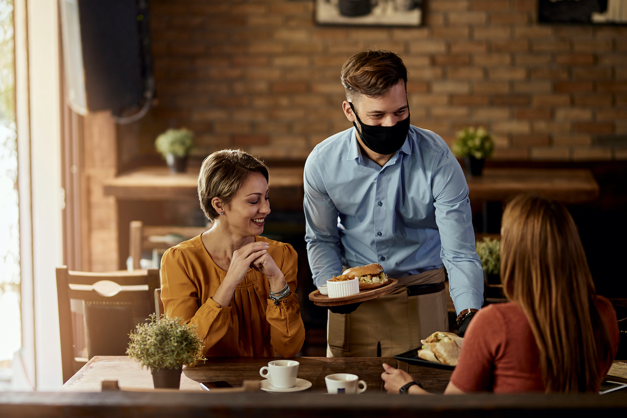 Restaurant worker serves customers