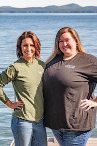 Campfire Booking Photo of Owners, Mandy Caruso and Ashley Hanson standing in front of Sebago Lake