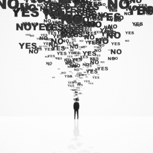black and white image of a person in a black suit on a white background with many Yes's and No's streaming out of their head into a cloud of confusion in the sky