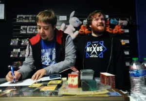 Mark Blaschke and Nicholas Murray, the partners behind The Nexus Arcade and Gaming Lounge at the front desk.