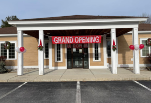 Front of Gray Urgent Care with balloons and red Grand Opening sign