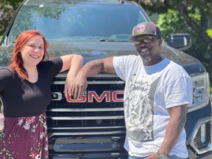 James Watson and Christina Ramsdell look proud in front of a new truck