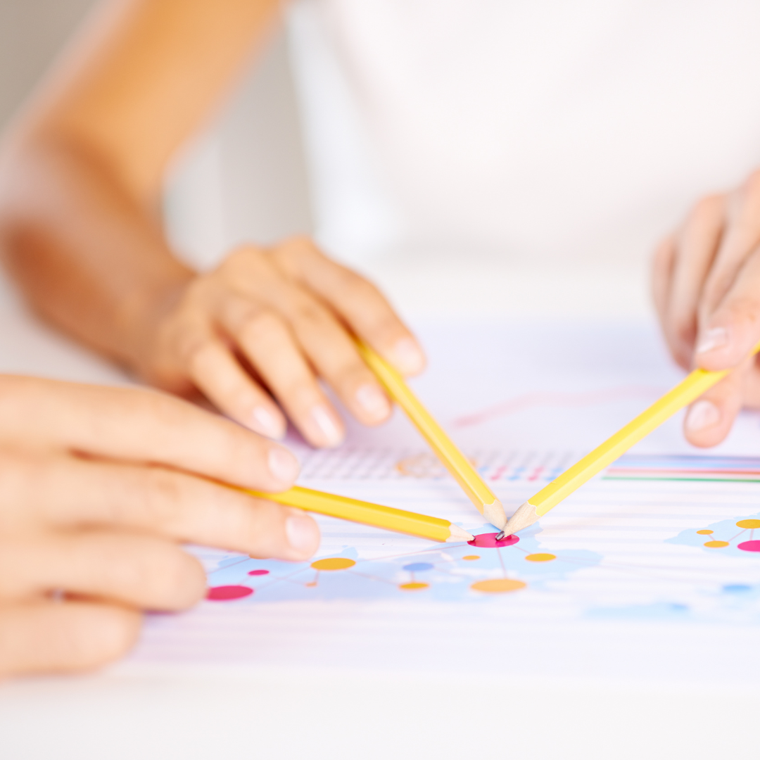 3 hands holding pencils, pointing at the same data point