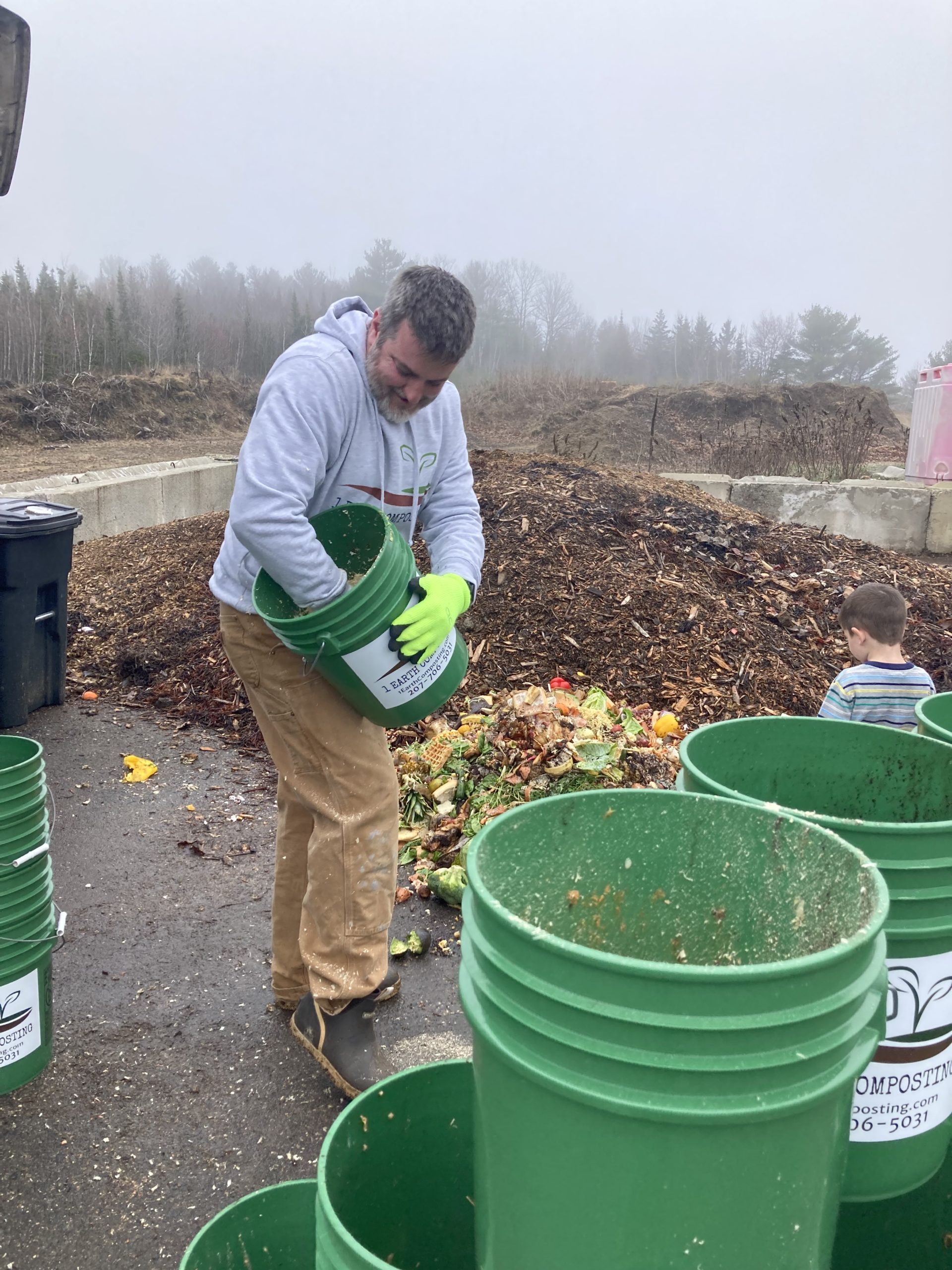 Matt Saunders of 1 Earth Composting with arm inside compost bucket