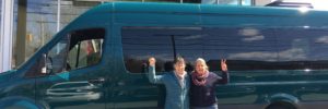 Ellen Finn of Cadillac Mtn. Summit Shuttle and Maine SBDC at CEI Business Advisor Ann McAlhany in front of the shuttle van