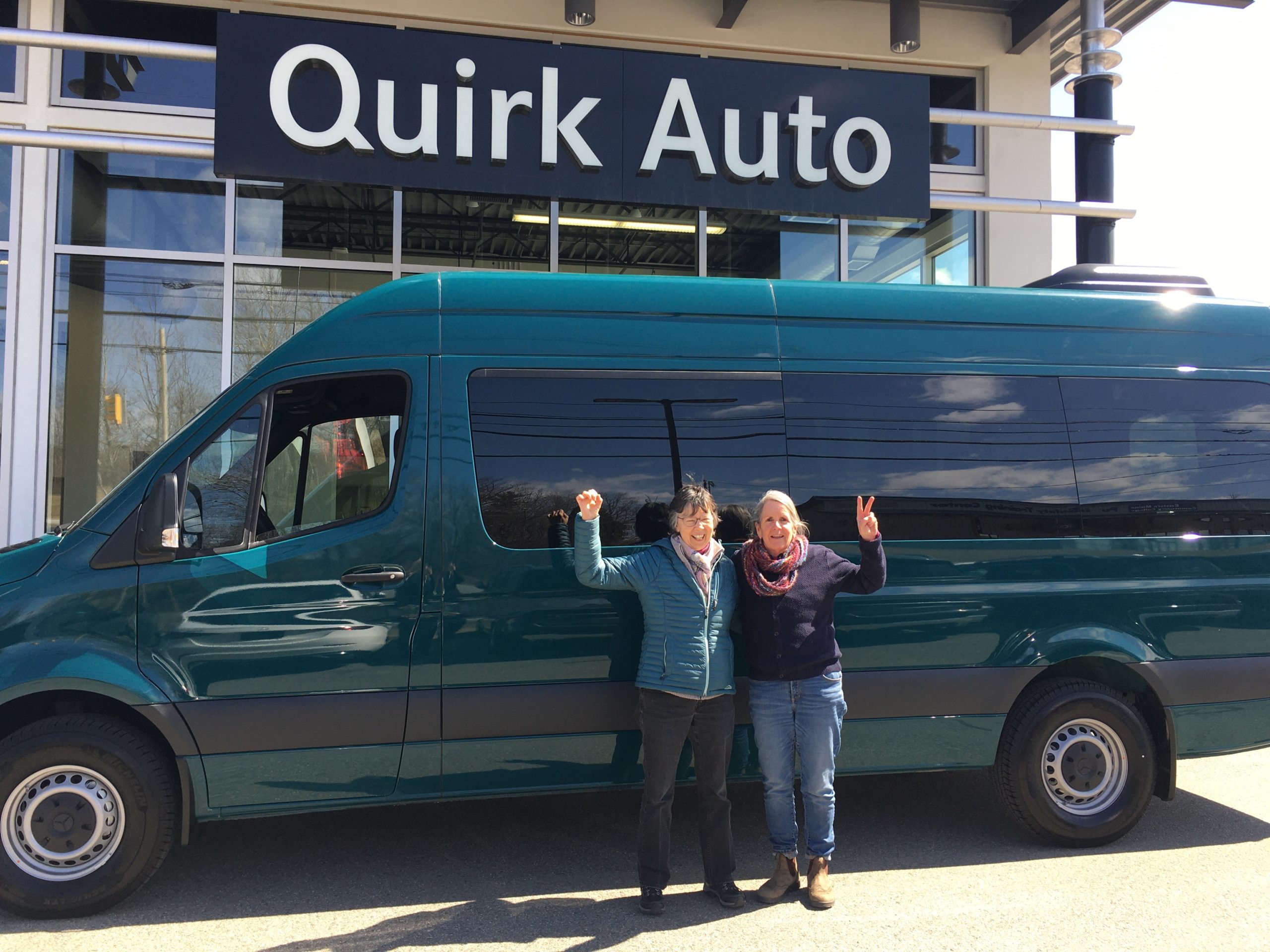 Ellen Finn of Cadillac Mtn. Summit Shuttle and Maine SBDC at CEI Business Advisor Ann McAlhany in front of the shuttle van