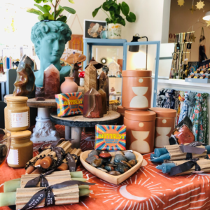 Rocks, candles and other happiness and wellness products on a table at Yarrow in Kittery, Maine
