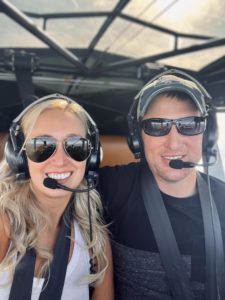 Chelsie Crane and her husband flying an airplane, close up image of their faces with headsets