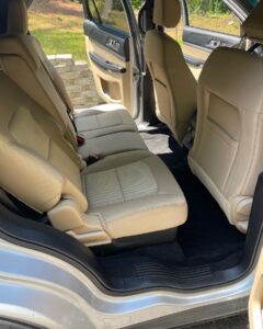 Inside of a car with clean tan seats. Detail done by Black Diamond Detailing.