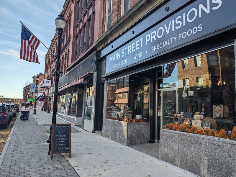 Front of building at Main Street Provisions with flag and sign