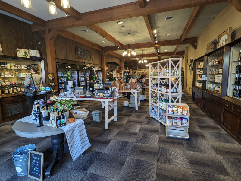 Inside of Main Street Provisions with lots of shelves filled with locally and regionally sourced food, beverages and gifts