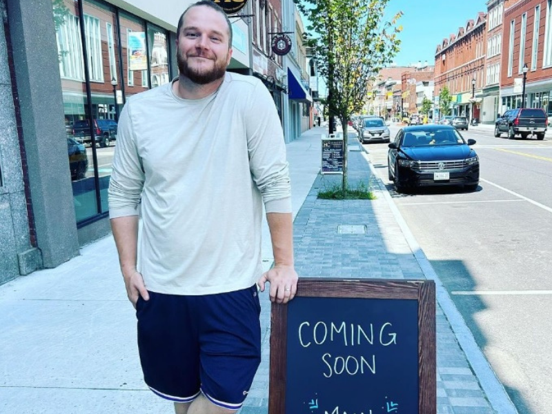 Zachary Brann of Main Street Provisions standing outside his location with a 