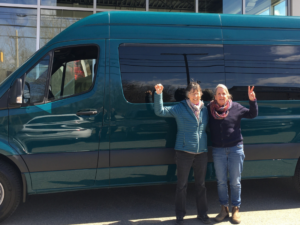 Business Advisor Ann McAlhany and Business Owner Ellen Fin in front of her new van which will help her provide rides up and down Cadillac Mountain Shuttle Service