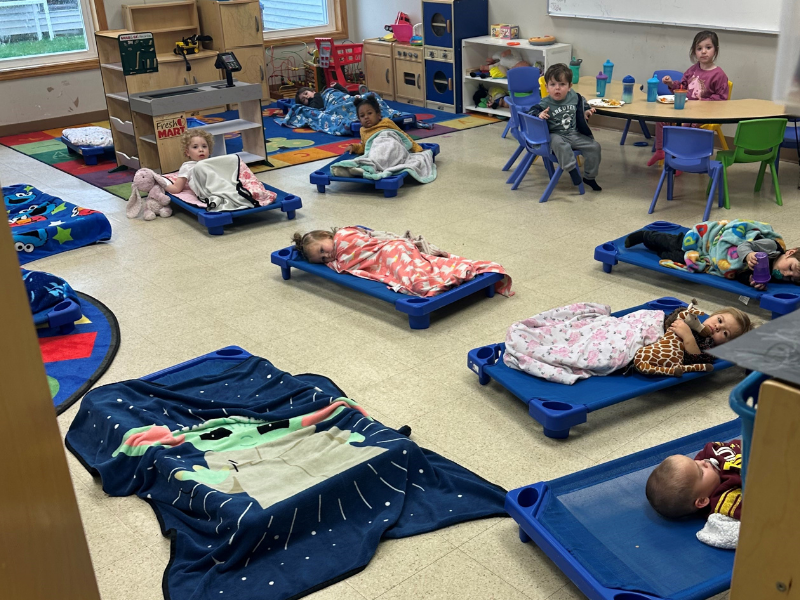 Young children resting on mats at Kelly's Place Learning Center